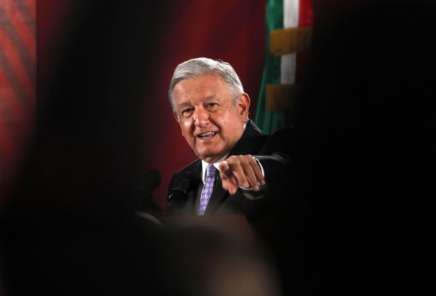 Mexican President Andres Manuel Lopez Obrador points to a reporter during his daily morning press conference at the National Palace in Mexico City, Wednesday, Nov. 13, 2019. Mexico has granted asylum to Bolivia's former President Evo Morales, who resigned on Nov. 10th under mounting pressure from the military and the public after his re-election victory triggered weeks of fraud allegations and deadly protests. (AP Photo/Marco Ugarte)