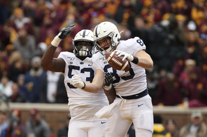 Penn State tight end Nick Bowers (83) celebrates with teammate offensive lineman Rasheed Walker (53) after Bowers scored a touchdown during an NCAA college football game against Minnesota, Saturday, Nov. 9, 2019, in Minneapolis. Minnesota won 31-26. (AP Photo/Stacy Bengs)