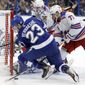 Tampa Bay Lightning center Carter Verhaeghe (23) gets knocked down by New York Rangers defenseman Tony DeAngelo (77) during the second period of an NHL hockey game Thursday, Nov. 14, 2019, in Tampa, Fla. (AP Photo/Chris O&#39;Meara)