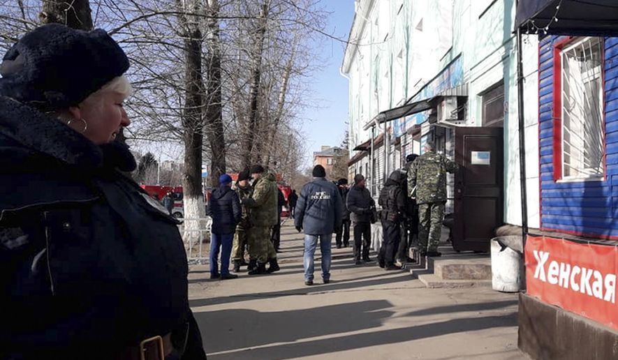 In this photo provided by Vera Zaderko, police secure an area at a college in Blagoveshchensk, Russia, Thursday, Nov. 14, 2019. Russia's state Investigative Committee said the 19-year-old college student in Blagoveshchensk near the border with China brought a hunting rifle to class Thursday and opened fire on students, shooting one dead and severely injuring three more. It wasn't immediately clear what prompted the attack. The attacker shot himself soon after the police arrived. (Vera Kulikova via AP)
