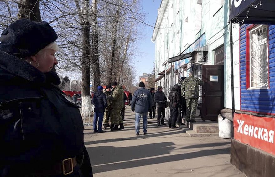 In this photo provided by Vera Zaderko, police secure an area at a college in Blagoveshchensk, Russia, Thursday, Nov. 14, 2019. Russia's state Investigative Committee said the 19-year-old college student in Blagoveshchensk near the border with China brought a hunting rifle to class Thursday and opened fire on students, shooting one dead and severely injuring three more. It wasn't immediately clear what prompted the attack. The attacker shot himself soon after the police arrived. (Vera Kulikova via AP)