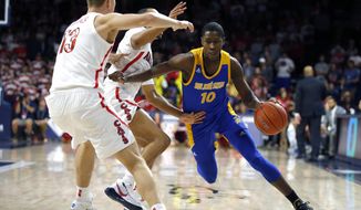 San Jose State guard Omari Moore (10) drives on Arizona&#39;s Jemarl Baker Jr. and Stone Gettings (13) during the first half of an NCAA college basketball game Thursday, Nov. 14, 2019, in Tucson, Ariz. (AP Photo/Rick Scuteri)