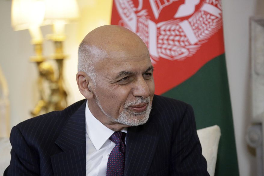 FILE - In this June 17, 2019 file photo, Afghanistan's President Ashraf Ghani speaks with British Prime Minister Theresa May at the start of their meeting inside 10 Downing Street in London. Three Taliban prisoners who were to be freed in exchange for an American and an Australian national, both kidnapped in 2016, are still in custody in Bagram prison, north of the capital Kabul, Taliban spokesman Zabihullah Mujahid said Friday, Nov. 15. The three Taliban prisoners did not show up at an exchange site that had been agreed upon with the U.S., though Ghani said they would be freed. (AP Photo/Matt Dunham, Pool, File)