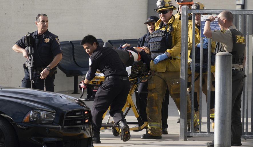 Emergency personnel remove an injured person following a shooting at Saugus High School, Thursday, Nov. 14, 2015 in Santa Clarita, Calif. (David Crane/The Orange County Register via AP)
