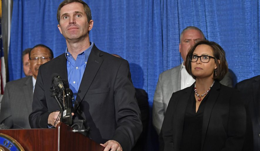 Kentucky Governor-Elect Andy Beshear, left, and Lt. Governor-Elect Jacqueline Coleman speak with reporters following the announcement of their transition team at the Capitol Rotunda in Frankfort, Ky., Friday, Nov. 15, 2019. (AP Photo/Timothy D. Easley)