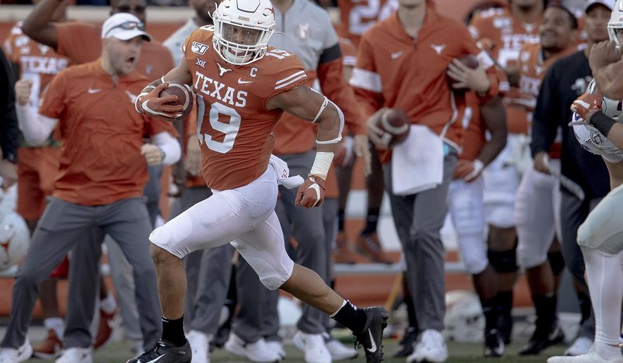 Texas defensive back Brandon Jones (19) returns a punt against Kansas State during an NCAA college football game Saturday, Nov. 9, 2019, in Austin, Texas. (Nick Wagner/Austin American-Statesman via AP)