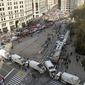 In this Monday, Nov. 11, 2019 file photo, sanitation and other utility trucks block off the streets around Madison Square Park as crowds and protesters gather for President Donald Trump&#39;s address to kick off the New York City&#39;s 100th annual Veterans Day parade in New York. The 2020 parade was canceled due to the coronavirus pandemic, but returned to 5th Avenue on Nov. 11, 2021, featuring marching units, vintage military vehicles and elected officials including Mayor Bill de Blasio. (Judy Wolfe via AP)  **FILE**