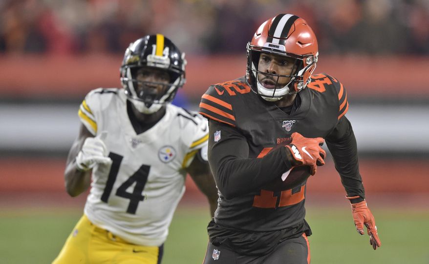 Cleveland Browns strong safety Morgan Burnett (42) returns an interception as Pittsburgh Steelers wide receiver Tevin Jones pursues during the first half of an NFL football game Thursday, Nov. 14, 2019, in Cleveland. (AP Photo/David Richard)