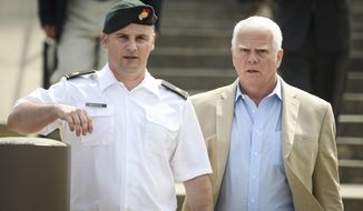 In this June 27, 2019, photo. Maj. Mathew Golsteyn, a former Army Special Forces soldier, leaves the Fort Bragg courtroom facility with his civilian lawyer, Phillip Stackhouse, right, after an arraignment hearing. President Donald Trump has pardoned a former U.S. Army commando set to stand trial next year in the killing of a suspected Afghan bomb-maker and for a former Army lieutenant who had been convicted of murder after he ordered his men to fire upon three Afghans, killing two, the White House announced late Friday. (Andrew Craft/The Fayetteville Observer via AP) **FILE**