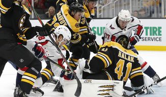 Washington Capitals&#39; T.J. Oshie (77) tries to get a shot past Boston Bruins&#39; Jaroslav Halak (41) during the second period of an NHL hockey game in Boston, Saturday, Nov. 16, 2019. (AP Photo/Michael Dwyer) ** FILE **