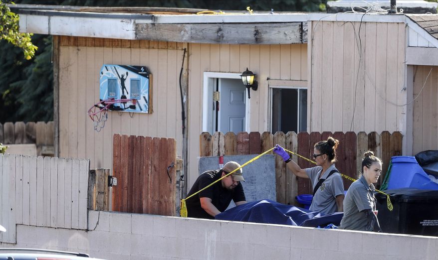 A body is carried out on a gurney at the home where two adults and three children died from gunshot wounds during a domestic shooting in the Paradise Hills area in San Diego, Calif., Saturday, Nov. 16, 2019. A husband and wife and three of their young children died Saturday morning at the family's San Diego home in what police believe was a murder-suicide sparked by a bitter divorce. One son is in critical condition. (Hayne Palmour IV/The San Diego Union-Tribune via AP)