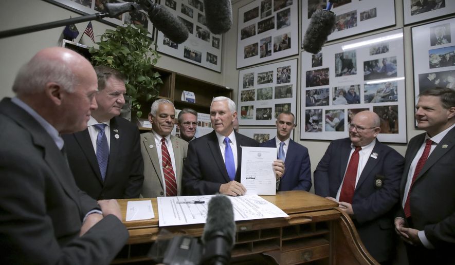 FILE - In this Thursday, Nov. 7, 2019, file photo, Republican Vice President Mike Pence, center, speaks to Secretary of State Bill Gardner, left, as Pence files for President Donald Trump to be listed on the New Hampshire primary ballot in Concord, N.H. At right is New Hampshire Gov. Chris Sununu. The quadrennial chaos has quieted down over at the New Hampshire secretary of state’s office with the closing of the filing period for the first-in-the-nation presidential primary. (AP Photo/Charles Krupa, File)