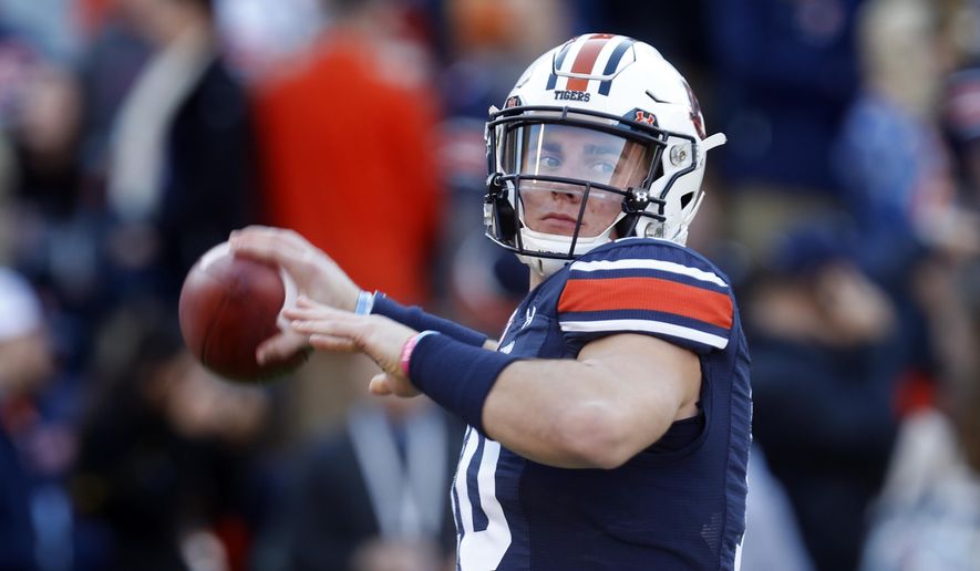 Auburn quarterback Bo Nix (10) warms up before an NCAA college football game against Georgia, Saturday, Nov. 16, 2019, in Auburn, Ala. (AP Photo/Butch Dill)