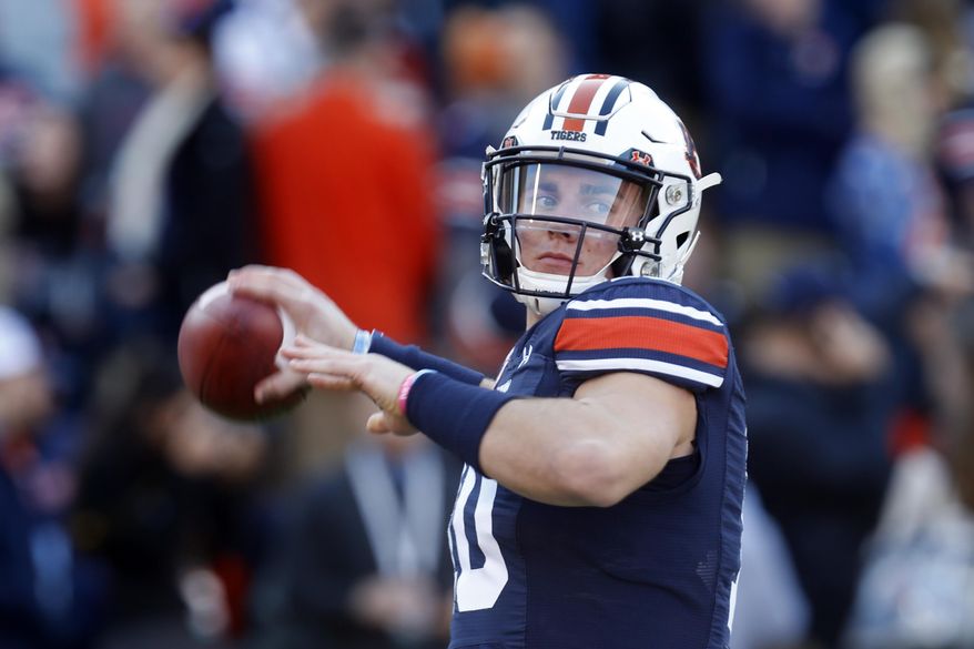 Auburn quarterback Bo Nix (10) warms up before an NCAA college football game against Georgia, Saturday, Nov. 16, 2019, in Auburn, Ala. (AP Photo/Butch Dill)