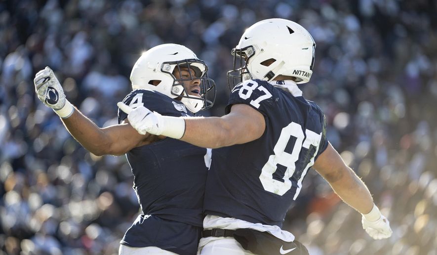 Penn State running back Journey Brown (4) celebrates with tight end Pat Freiermuth (87) after scoring on a 35-yard touchdown in the third quarter of an NCAA college football game against Indiana in State College, Pa., on Saturday, Nov.16, 2019. Penn State defeated 34-27. (AP Photo/Barry Reeger)