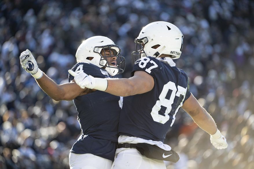 Penn State running back Journey Brown (4) celebrates with tight end Pat Freiermuth (87) after scoring on a 35-yard touchdown in the third quarter of an NCAA college football game against Indiana in State College, Pa., on Saturday, Nov.16, 2019. Penn State defeated 34-27. (AP Photo/Barry Reeger)