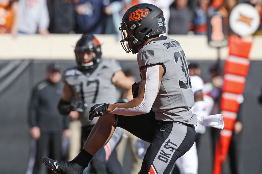 Oklahoma State running back Chuba Hubbard (30) runs into the end zone for a touchdown in the first half of an NCAA college football game against Kansas in Stillwater, Okla., Saturday, Nov. 16, 2019. (AP Photo/Sue Ogrocki)