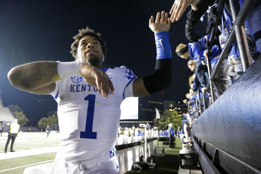 Kentucky's Lynn Bowden Jr. celebrates with fans after an NCAA college football game against Vanderbilt, Saturday, Nov. 16, 2019, in Nashville, Tenn. (AP Photo/Mark Humphrey)