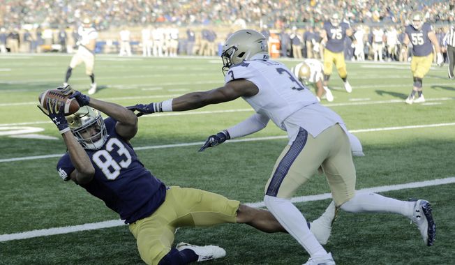 Notre Dame wide receiver Chase Claypool (83) makes a touchdown reception against Navy cornerback Cameron Kinley (3) during the first half of an NCAA college football game, Saturday, Nov. 16, 2019, in South Bend, Ind.(AP Photo/Darron Cummings) ** FILE **