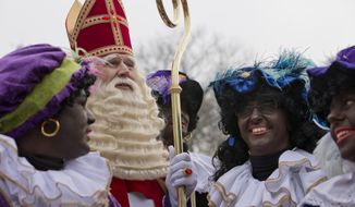 -FILE- In this Saturday Nov. 16, 2013, image The Dutch version of Santa Claus, Sinterklaas, or Saint Nicholas, and his blackface sidekicks &amp;quot;Zwarte Piet&amp;quot; or &amp;quot;Black Pete&amp;quot; arrive by steamboat in Hoorn, north-western Netherlands. Saint Nicholas is due to arrive in the Netherlands Saturday Nov. 16, 2019, in an annual children&#39;s party that has become the backdrop for increasingly acrimonious confrontations between supporters and opponents of his sidekick, Black Pete, a depictions which opponents say promotes racist stereotypes. (AP Photo/Peter Dejong, File)