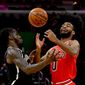Brooklyn Nets forward Taurean Prince, left, and Chicago Bulls guard Coby White try to gather in a loose ball during the first half of an NBA basketball game Saturday, Nov. 16, 2019, in Chicago. (AP Photo/Matt Marton)