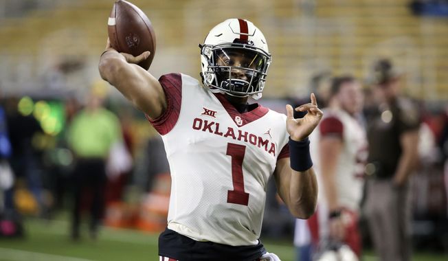 Oklahoma quarterback Jalen Hurts warms up prior to an NCAA college football game against Baylor in Waco, Texas, Saturday, Nov. 16, 2019. (AP Photo/Ray Carlin)