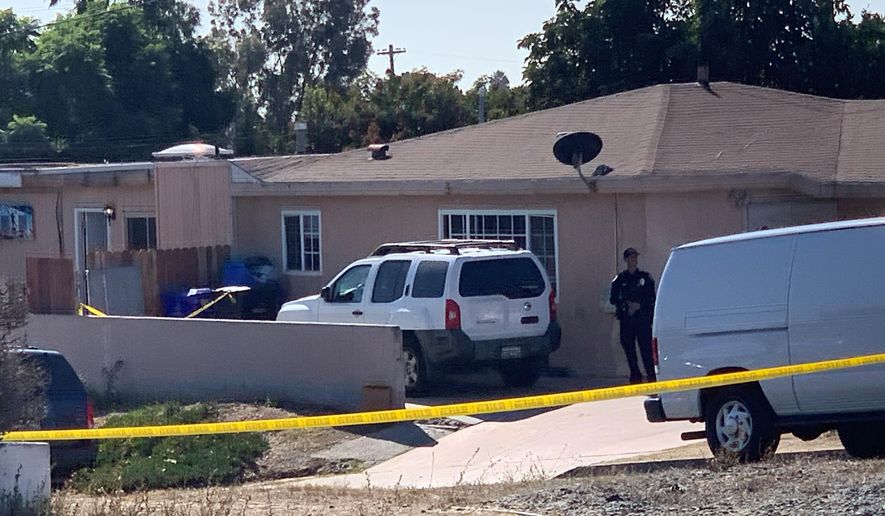 San Diego police investigate a shooting that killed five members of a family and wounded one more in Paradise Hills on Saturday, Nov. 16, 2019 in San Diego, Calif. Police said two adults and three children were shot to death and a fourth child was hospitalized with injuries in an apparent murder-suicide in San Diego. (Hayne Palmour/The San Diego Union-Tribune via AP)