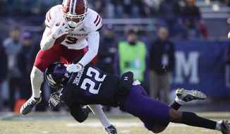Massachusetts&#39; Isaiah Rodgers, left, is tackled by Northwestern&#39;s Bryce Jackson during the second half of an NCAA college football game Saturday, Nov. 16, 2019, in Evanston, Ill. (AP Photo/Jim Young)