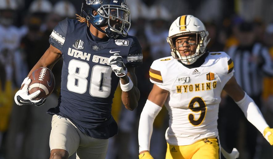 Utah State wide receiver Siaosi Mariner (80) runs down the field for an 80 yard touchdown reception as Wyoming cornerback Tyler Hall (9) defends during the first half of an NCAA football game Saturday, Nov. 16, 2019, in Logan, Utah. (Eli Lucero/The Herald Journal via AP)