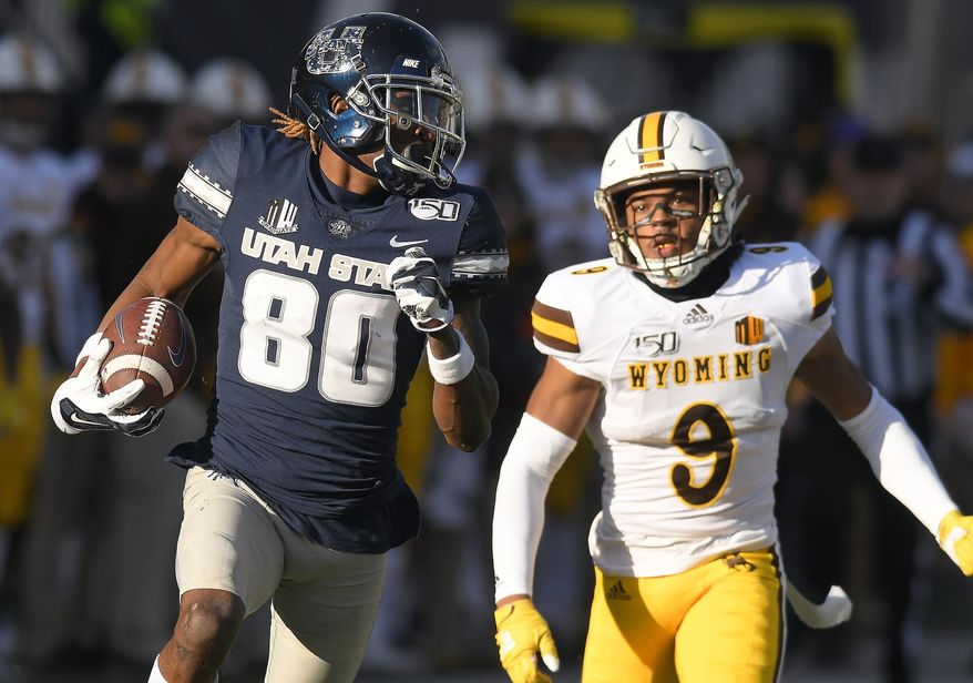 Utah State wide receiver Siaosi Mariner (80) runs down the field for an 80 yard touchdown reception as Wyoming cornerback Tyler Hall (9) defends during the first half of an NCAA football game Saturday, Nov. 16, 2019, in Logan, Utah. (Eli Lucero/The Herald Journal via AP)