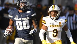 Utah State wide receiver Siaosi Mariner (80) runs down the field for an 80 yard touchdown reception as Wyoming cornerback Tyler Hall (9) defends during the first half of an NCAA football game Saturday, Nov. 16, 2019, in Logan, Utah. (Eli Lucero/The Herald Journal via AP)