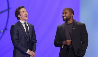 Kanye West, right, answers questions from senior pastor Joel Osteen, left, during a service at Lakewood Church, Sunday, Nov. 17, 2019, in Houston. (AP Photo/Michael Wyke)