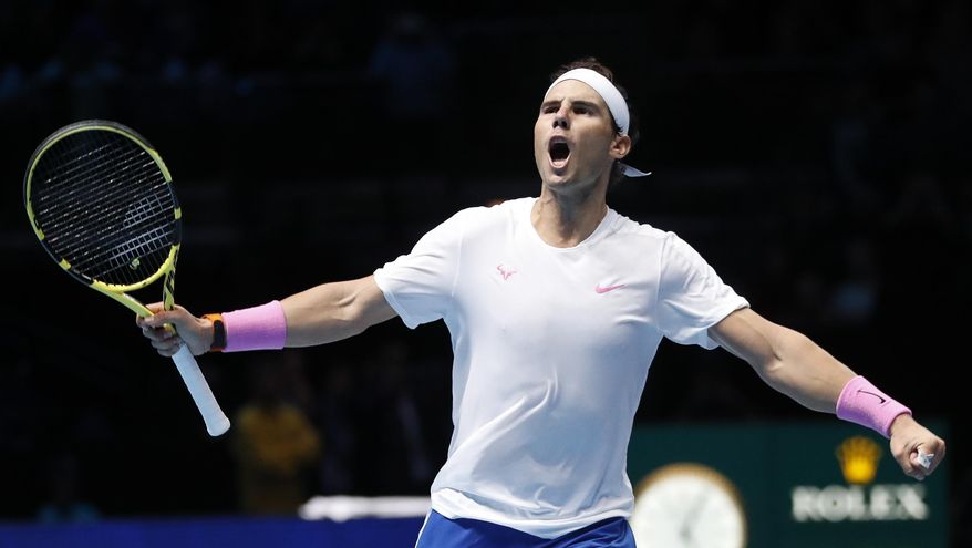 Spain's Rafael Nadal celebrates after defeating Stefanos Tsitsipas of Greece in their ATP World Tours Finals singles tennis match at the O2 Arena in London, Friday, Nov. 15, 2019. (AP Photo/Alastair Grant)