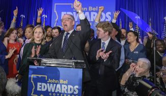 Louisiana Gov. John Bel Edwards arrives to address supporters at his election night watch party in Baton Rouge, La., Saturday, Nov. 16, 2019. (AP Photo/Matthew Hinton)