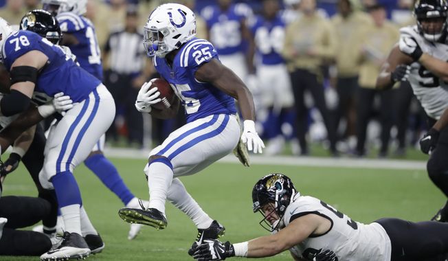 Indianapolis Colts&#x27; Marlon Mack (25) runs past dJacksonville Jaguars&#x27; Taven Bryan (90) during the second half of an NFL football game, Sunday, Nov. 17, 2019, in Indianapolis. (AP Photo/Michael Conroy)