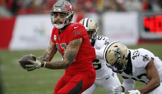 Tampa Bay Buccaneers wide receiver Mike Evans (13) makes a catch in front of New Orleans Saints cornerback P.J. Williams (26) and free safety Marcus Williams (43) during the second half of an NFL football game Sunday, Nov. 17, 2019, in Tampa, Fla. (AP Photo/Mark LoMoglio)