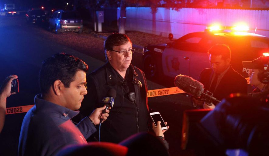 Fresno Police Lt. Bill Dooley speaks to reporters at the scene of a shooting at a backyard party Sunday, Nov. 17, 2019, in southeast Fresno, Calif. Multiple people were shot and at least four of them were killed Sunday at a party in Fresno when suspects sneaked into the backyard and fired into the crowd, police said. (Larry Valenzuela/The Fresno Bee via AP)