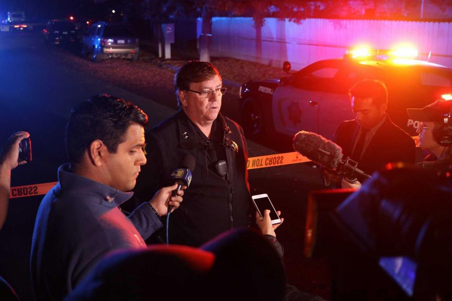 Fresno Police Lt. Bill Dooley speaks to reporters at the scene of a shooting at a backyard party Sunday, Nov. 17, 2019, in southeast Fresno, Calif. Multiple people were shot and at least four of them were killed Sunday at a party in Fresno when suspects sneaked into the backyard and fired into the crowd, police said. (Larry Valenzuela/The Fresno Bee via AP)