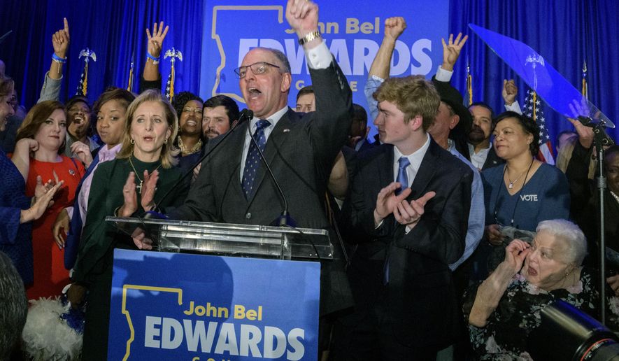 FILE - In this Saturday, Nov. 16, 2019 file photo, Louisiana Gov. John Bel Edwards arrives to address supporters at his election night watch party in Baton Rouge, La. A re-election victory by Edwards has assured Democrats of an all-important place at the table when political maps are redrawn after the 2020 census for future elections to Congress and the state legislature. Edwards’ narrow triumph on Saturday marked the third significant win in a Southern state in two weeks for Democrats, following their takeover of the Virginia General Assembly and the defeat of Republican Kentucky Gov. Matt Bevin by Democratic Attorney General Andy Beshear. (AP Photo/Matthew Hinton, File)