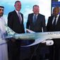 Etihad COO Mohammad al-Bulooki, left, Etihad CEO Tony Douglas, second left, Boeing Commercial Airplanes president and CEO Stanley A. Deal, third left, and Boeing Global Services President and CEO Ted Colbert, right, pose in front of a Boeing 787 Dreamliner model at the Dubai Airshow in Dubai, United Arab Emirates, Monday, Nov. 18, 2019. Abu Dhabi&#39;s flagship carrier Etihad said Monday it had partnered with Boeing Co. to launch what they say will be one of the world&#39;s most fuel-efficient long haul airplanes as the company seeks to save costs on fuel and position itself as a more environmentally-conscious choice for travelers. (AP Photo/Jon Gambrell)