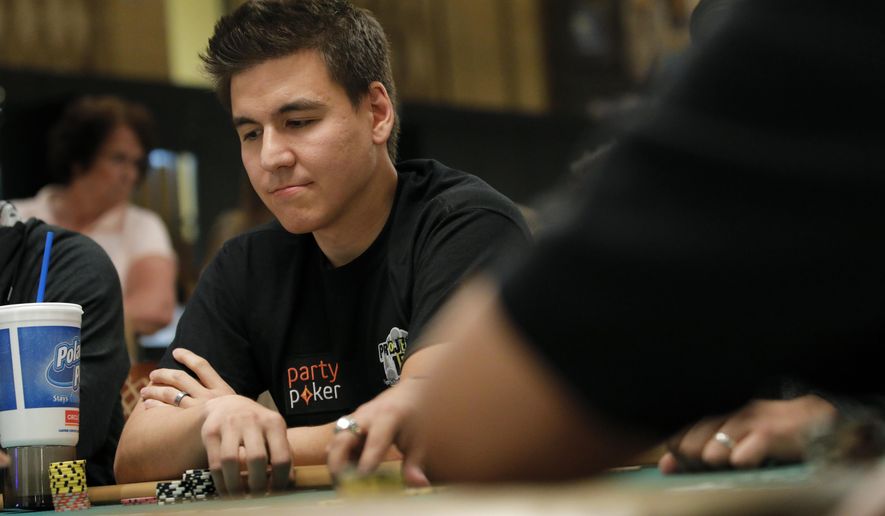 FILE - In this Monday, June 24, 2019, file photo, "Jeopardy!" champion and professional sports gambler James Holzhauer plays in a tournament at the World Series of Poker, in Las Vegas. The three top money winners in “Jeopardy!” history, Ken Jennings, Brad Rutter and James Holzhauer, will vie for a share of $1.5 million in January 2020. (AP Photo/John Locher, File)