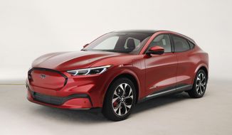 In this Wednesday, Oct. 30, 2019 photo, the new Ford Mustang Mach-E SUV is shown in Warren, Mich. Ford is hoping to score big with the electric SUV for daily drivers that sort of looks like a Mustang performance car. The new SUV, to be unveiled just ahead of the Los Angeles Auto Show press days, should have range of up to 300 miles. It&#39;s one of dozens of electric vehicles coming globally by 2022. Automakers are eyeing what they think will be a growing market in the years to come. (AP Photo/Carlos Osorio)