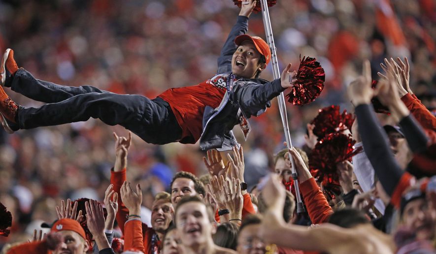 Utah fans celebrate a fumble recovery and touchdown during the first half of the team's NCAA college football game against Utah on Saturday, Nov. 16, 2019, in Salt Lake City. (AP Photo/Rick Bowmer)