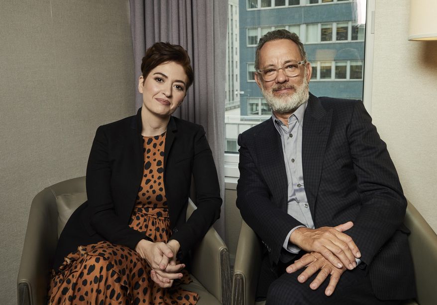 This Nov. 17, 2019 photo shows Marielle Heller, left, and Tom Hanks pose for a portrait in New York to promote their film, "A Beautiful Day In The Neighborhood." (Photo by Matt Licari/Invision/AP)