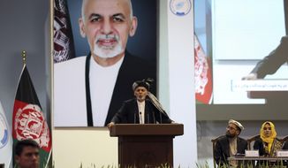 FILE - In this May 3, 2019, photo, Afghan President Ashraf Ghani speaks on the last day of the Afghan Loya Jirga meeting in Kabul, Afghanistan. Taliban officials have told The Associated Press that three Taliban prisoners released by Kabul have been flown to Qatar for a swap for an American and an Australian hostage held by the insurgents. The three Taliban prisoners were to have been freed more than one week ago by Afghan President Ashraf Ghani. (AP Photo/Rahmat Gul, File)