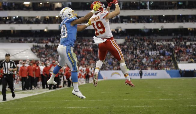 Kansas City Chiefs defensive back Daniel Sorensen, right, intercepts a pass intended for Los Angeles Chargers running back Austin Ekeler, left, during the second half of an NFL football game Monday, Nov. 18, 2019, in Mexico City. (AP Photo/Marcio Jose Sanchez)