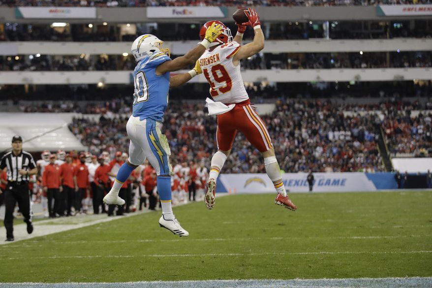 Kansas City Chiefs defensive back Daniel Sorensen, right, intercepts a pass intended for Los Angeles Chargers running back Austin Ekeler, left, during the second half of an NFL football game Monday, Nov. 18, 2019, in Mexico City. (AP Photo/Marcio Jose Sanchez)