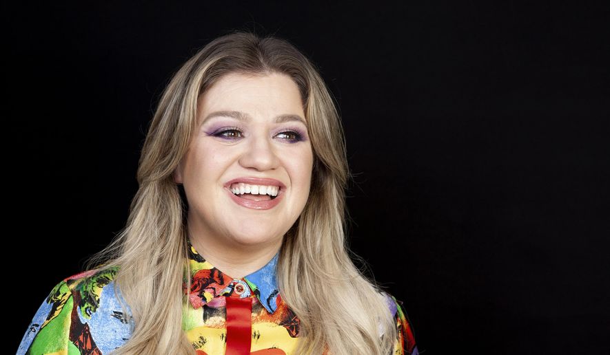 FILE - This April 14, 2019 file photo shows singer and actress Kelly Clarkson posing for a portrait at the Four Seasons Hotel in Los Angeles. Clarkson has been named the godmother of Norwegian Cruise Line’s newest ship Norwegian Encore, and the pop star said she signed on to the project because it aligned with the things that’s most important to her life: families spending time together, humanitarian work, and live music. (Photo by Rebecca Cabage/Invision/AP, File)