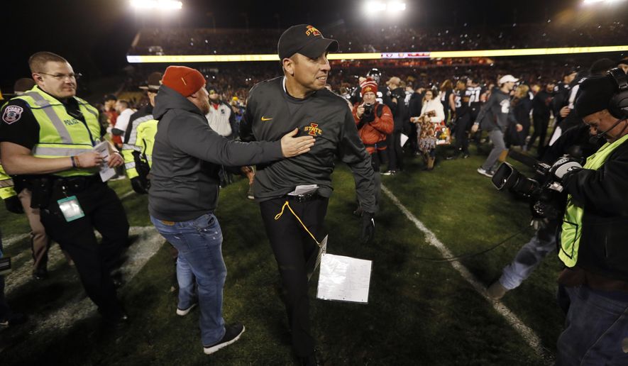Iowa State head coach Matt Campbell, center, celebrates with fans after an NCAA college football game against Texas, Saturday, Nov. 16, 2019, in Ames, Iowa. Iowa State won 23-21. (AP Photo/Charlie Neibergall)