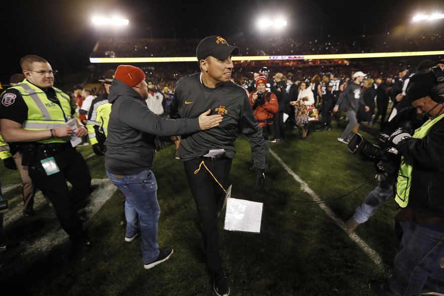 Iowa State head coach Matt Campbell, center, celebrates with fans after an NCAA college football game against Texas, Saturday, Nov. 16, 2019, in Ames, Iowa. Iowa State won 23-21. (AP Photo/Charlie Neibergall)
